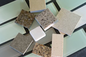 Glass subway tile samples used in kitchen backsplashes and quartz samples for countertops