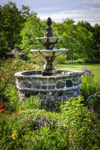 Lush green garden with tiered stone fountain