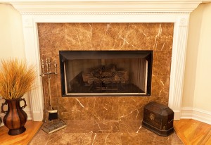 Residential gas fireplace with brown marble tile